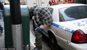 New York protestor defectates on a police car.