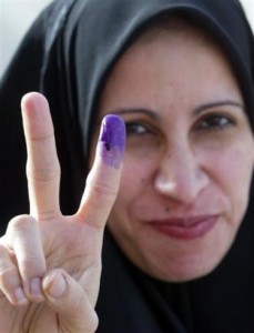 purple_finger An Iraqi woman flashes victory after voting.